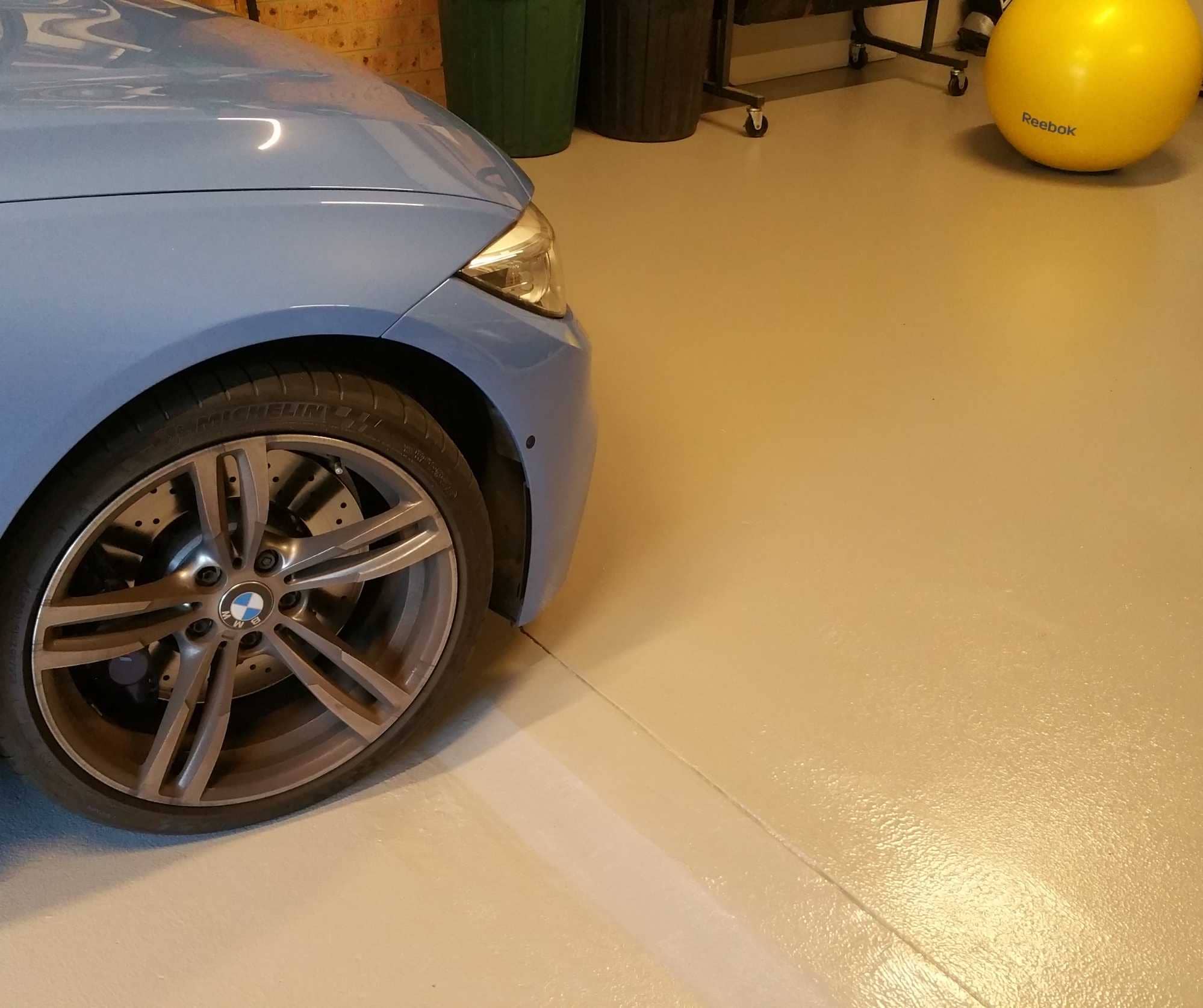 Plain epoxy garage flooring in Sydney with vehicle parked on finished floor