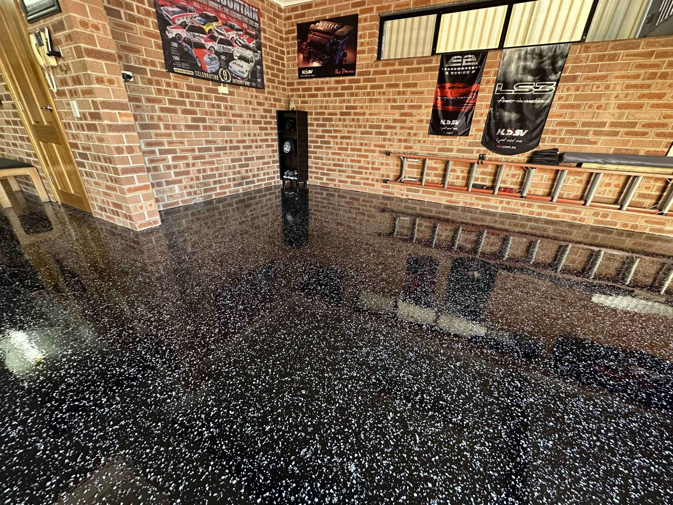 Black flake garage entry epoxy floor in Sydney with gloss finish