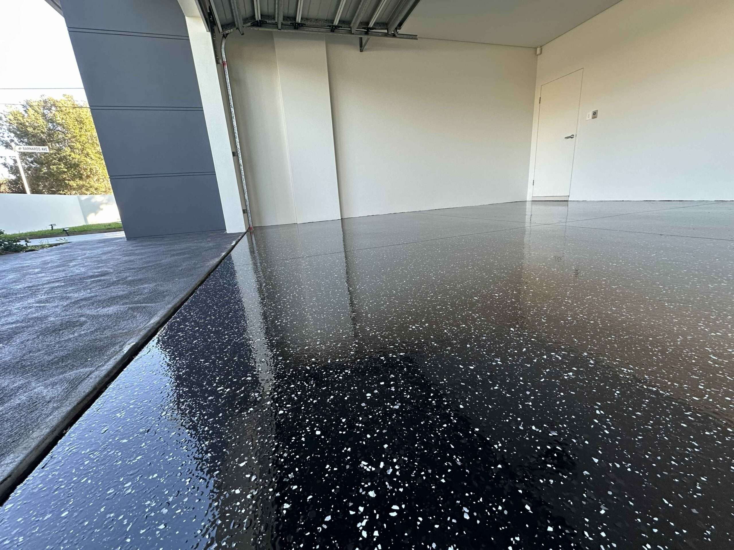 Black full flake garage epoxy flooring in Sydney with high gloss finish