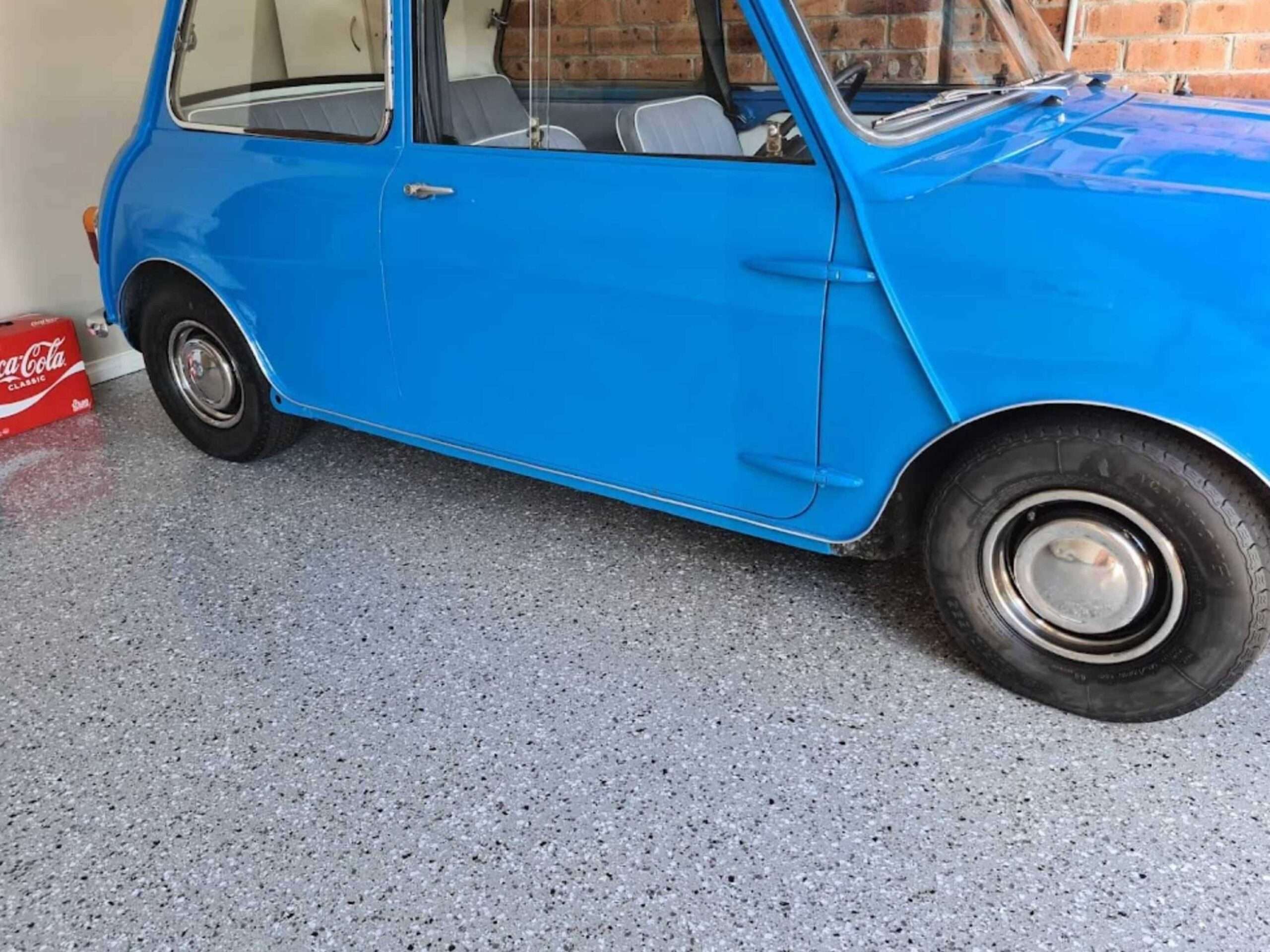 Blue classic car parked on grey flake garage epoxy flooring in Sydney
