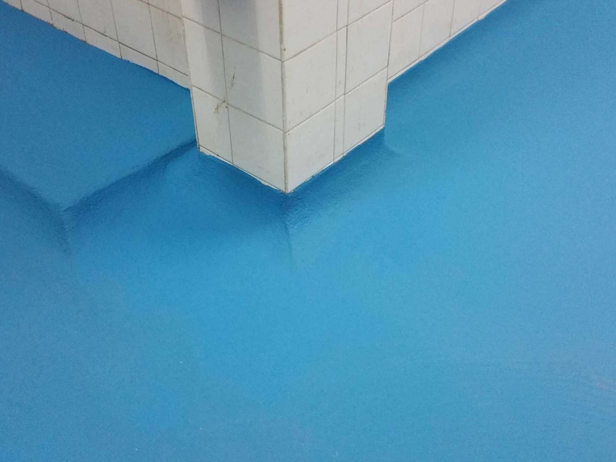 Commercial kitchen epoxy coving around tiled wall in Sydney