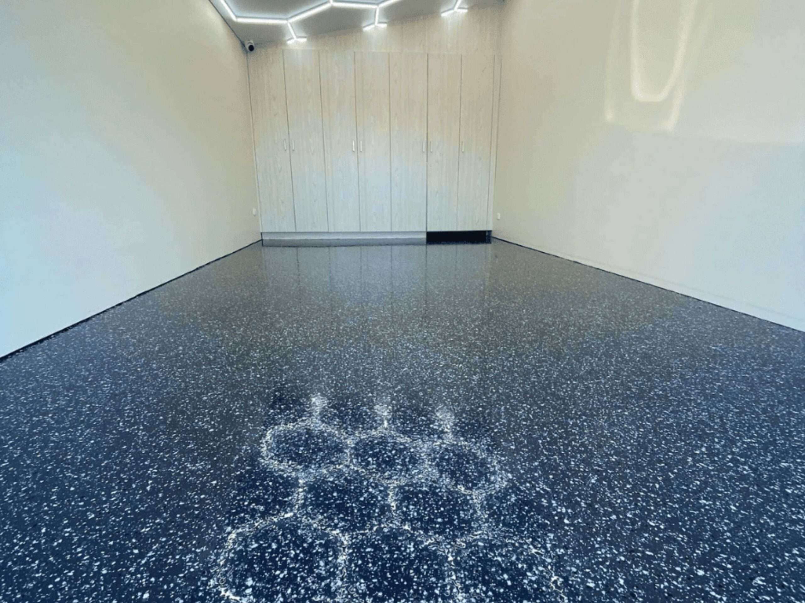 Dark blue flake garage epoxy flooring in Sydney with glossy finish