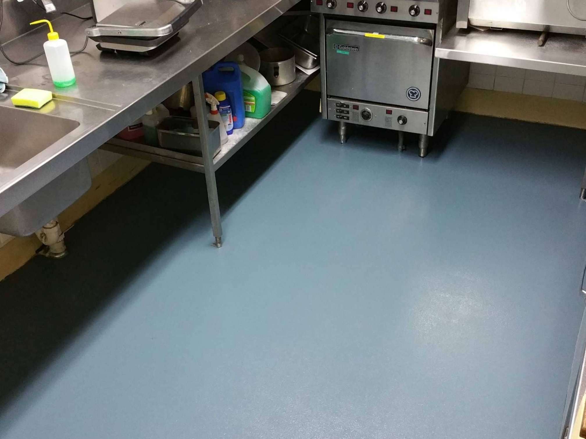 Non-slip epoxy flooring in restaurant kitchen under stainless steel equipment in Sydney